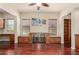 Elegant living room with hardwood floors, custom built-ins, and beverage refrigerators at 26747 N 127Th Dr, Peoria, AZ 85383