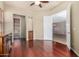 Living room area with hardwood floors and access to an outdoor patio through sliding glass doors at 26747 N 127Th Dr, Peoria, AZ 85383