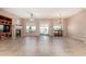 Spacious living room with tiled floors, a fireplace, built-in media center, and sliding glass doors at 26747 N 127Th Dr, Peoria, AZ 85383