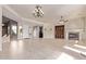 Expansive living area featuring tile floors, a fireplace, and seamless access to other rooms at 26747 N 127Th Dr, Peoria, AZ 85383