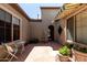 Inviting courtyard with a small table and chairs, plants, and a partial awning for shade at 26747 N 127Th Dr, Peoria, AZ 85383