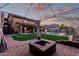 Beautiful backyard with synthetic lawn, brick pavers, a fire pit, and outdoor seating space at 14244 W Indianola Ave, Goodyear, AZ 85395