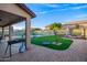 Spacious backyard with artificial turf, mature landscaping, and a paved patio area for entertaining at 14244 W Indianola Ave, Goodyear, AZ 85395