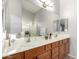 Bathroom with an expansive vanity area, a large mirror, and a shower offering a serene experience at 14244 W Indianola Ave, Goodyear, AZ 85395