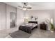 A spacious bedroom boasts lots of light, a ceiling fan, and a gray rug provides a comfortable space at 14244 W Indianola Ave, Goodyear, AZ 85395