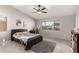 Relaxing bedroom featuring neutral tones, a ceiling fan, and large window for ample natural light at 14244 W Indianola Ave, Goodyear, AZ 85395