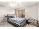 Bright bedroom with a gray upholstered bed frame, window with blinds, and a telescope at 14244 W Indianola Ave, Goodyear, AZ 85395