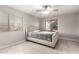 Light bedroom featuring a neutral palette, two windows, and a comfortable bed for relaxation at 14244 W Indianola Ave, Goodyear, AZ 85395