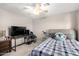 This bedroom is furnished with a full size bed, desk and chair, ceiling fan, and telescope at 14244 W Indianola Ave, Goodyear, AZ 85395