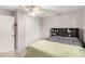 Standard bedroom includes a queen bed with headboard, ceiling fan, a closet with white sliding doors at 14244 W Indianola Ave, Goodyear, AZ 85395