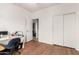 Bright bedroom with a desk area and wood-look flooring provides a versatile living space at 14244 W Indianola Ave, Goodyear, AZ 85395