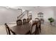 Elegant dining room featuring a large table with seating for eight and a view of the stairs at 14244 W Indianola Ave, Goodyear, AZ 85395