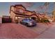 Side view of a two-story home with desert landscaping, a two-car garage, and a long driveway at 14244 W Indianola Ave, Goodyear, AZ 85395