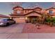 Charming two-story home featuring a well-maintained yard with desert landscaping and a two-car garage at 14244 W Indianola Ave, Goodyear, AZ 85395