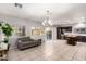 Open-concept living area with tile floors, a couch, and a view to the backyard at 14244 W Indianola Ave, Goodyear, AZ 85395
