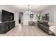Spacious living room with tile floors, a modern couch, and a view into another room at 14244 W Indianola Ave, Goodyear, AZ 85395