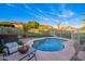 A private fenced pool and patio offers a relaxing outdoor retreat with synthetic turf lawn at 14244 W Indianola Ave, Goodyear, AZ 85395