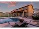 Inviting backyard pool enclosed by white metal fence, complemented by cozy outdoor seating area at 14244 W Indianola Ave, Goodyear, AZ 85395