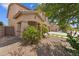 View of the home's entrance with lush landscaping at 44538 W Canyon Creek Dr, Maricopa, AZ 85139