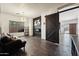 Living room features a black barn door and fireplace at 44538 W Canyon Creek Dr, Maricopa, AZ 85139