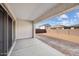 Covered back patio offering an outdoor living space with concrete flooring and views of the fenced backyard at 8746 W Denton Ln, Glendale, AZ 85305