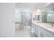 Spacious bathroom featuring double sinks, tile flooring, a soaking tub, and a separate glass shower at 8746 W Denton Ln, Glendale, AZ 85305