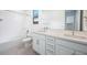 Bright bathroom featuring dual sinks, quartz counters and tile flooring at 8746 W Denton Ln, Glendale, AZ 85305