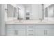 Bathroom featuring double sinks with modern fixtures and white cabinetry at 8746 W Denton Ln, Glendale, AZ 85305