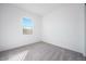 Bright bedroom features a cozy carpet, white walls, and a window providing natural light at 8746 W Denton Ln, Glendale, AZ 85305