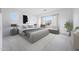 This bedroom offers a sitting area by the window, a neutral color palette and plenty of natural light at 8746 W Denton Ln, Glendale, AZ 85305