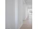 Bright hallway with neutral tiled floors and white walls leading to the main living areas at 8746 W Denton Ln, Glendale, AZ 85305