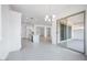 Bright, spacious kitchen with a center island, modern light fixtures, and sliding glass doors to the backyard at 8746 W Denton Ln, Glendale, AZ 85305