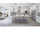 Bright kitchen features an island with bar seating, stainless steel appliances, and white cabinetry at 8746 W Denton Ln, Glendale, AZ 85305