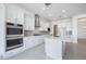 Bright, open kitchen with white cabinets, stainless steel appliances, and a large central island at 8746 W Denton Ln, Glendale, AZ 85305