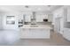 Spacious kitchen with white cabinets, a central island, and stainless steel appliances at 8746 W Denton Ln, Glendale, AZ 85305