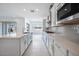 Modern kitchen showcasing white cabinets, quartz countertops, and stainless steel appliances at 8746 W Denton Ln, Glendale, AZ 85305