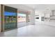Bright living room features tiled flooring, white walls, and sliding doors to the patio at 8746 W Denton Ln, Glendale, AZ 85305