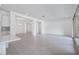 Open-concept living room with neutral floors, white walls, and recessed lighting throughout at 8746 W Denton Ln, Glendale, AZ 85305