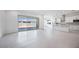 Bright living room showcasing an open floor plan, a modern kitchen, and large sliding glass doors to the outdoors at 8746 W Denton Ln, Glendale, AZ 85305