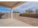 Covered patio overlooks a spacious backyard with block wall at 17993 W Long Lake Rd, Goodyear, AZ 85338