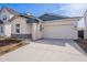 New construction home with two-tone exterior, attached garage, and landscaped front yard at 17993 W Long Lake Rd, Goodyear, AZ 85338