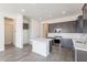 Modern kitchen with dark cabinetry, quartz countertops, and stainless steel appliances at 17993 W Long Lake Rd, Goodyear, AZ 85338