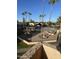 Community pool with palm trees and a relaxing patio area at 540 N May St # 3093, Mesa, AZ 85201