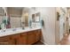 Double vanity bathroom with wood cabinets and large mirror at 15603 N 79Th N Dr, Peoria, AZ 85382