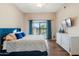 Main bedroom with sliding door to backyard and white dresser at 15603 N 79Th N Dr, Peoria, AZ 85382