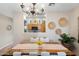 Dining area with wooden table, chandelier, and a view into the kitchen at 15603 N 79Th N Dr, Peoria, AZ 85382