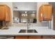 Kitchen features a large island with white countertops and stainless steel sink at 15603 N 79Th N Dr, Peoria, AZ 85382