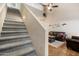 Gray carpeted staircase leading to upper level and living room at 15603 N 79Th N Dr, Peoria, AZ 85382