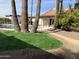 Relaxing pool area with palm trees, artificial turf, and a stone pathway at 7211 E Sunnyside Dr, Scottsdale, AZ 85260