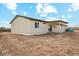 Back exterior view of home and covered patio with sliding glass doors and a view of the backyard at 13628 S 192Nd Ave, Buckeye, AZ 85326